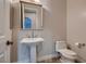 Powder room featuring a pedestal sink and toilet at 7521 Prancing Pony Ct, Las Vegas, NV 89131