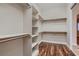 Spacious walk-in closet with custom shelving and wood flooring, offering ample storage at 7521 Prancing Pony Ct, Las Vegas, NV 89131