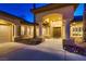 Close up of home's front entrance with decorative pillars, planters, and a tiled roof at 7521 Prancing Pony Ct, Las Vegas, NV 89131