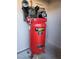 Garage featuring a professional Husky air compressor, mounted to a wall, for home improvement or automotive applications at 7521 Prancing Pony Ct, Las Vegas, NV 89131