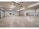 Spacious three-car garage with an open layout and shelving, perfect for vehicle storage and hobbies at 7521 Prancing Pony Ct, Las Vegas, NV 89131