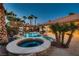 Backyard featuring a luxurious hot tub and custom pool with lush landscaping at 7521 Prancing Pony Ct, Las Vegas, NV 89131
