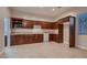View of kitchen area with wooden cabinets, granite countertops, white appliances, and ample storage space at 7521 Prancing Pony Ct, Las Vegas, NV 89131