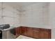 Well-equipped laundry room with a washer, sink, and ample cabinet space for storage and organization at 7521 Prancing Pony Ct, Las Vegas, NV 89131