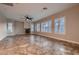 Open-concept living room with tile floors, fireplace, and custom shutters at 7521 Prancing Pony Ct, Las Vegas, NV 89131