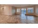 Bright living room featuring tile floors, recessed lighting and sliding glass doors to outside at 7521 Prancing Pony Ct, Las Vegas, NV 89131