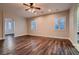 Open living room featuring wood floors, ceiling fan, and arched entrance at 7521 Prancing Pony Ct, Las Vegas, NV 89131