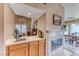 Convenient bar area adjacent to dining room with sink, built-in cabinets, and fireplace, ideal for entertaining guests at 7533 Grenfell Dr, Las Vegas, NV 89129