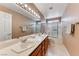 Large bathroom featuring dual sinks, a vanity mirror, and a glass-enclosed shower at 7533 Grenfell Dr, Las Vegas, NV 89129