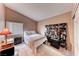 Comfortable bedroom with a ceiling fan, carpet, and a large window that provides natural light at 7533 Grenfell Dr, Las Vegas, NV 89129