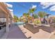 Beautiful backyard featuring a pool, an outdoor kitchen, and comfortable seating for entertaining guests at 7860 Villa Del Fuego, Las Vegas, NV 89131