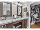 Bathroom with double sinks, granite counters, barn door mirrors, and walk-in closet at 7860 Villa Del Fuego, Las Vegas, NV 89131