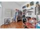Comfortable home office space with wooden floors, ample storage, and natural light from the window at 7860 Villa Del Fuego, Las Vegas, NV 89131