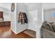 Neutral entryway features coat hooks, a clock, tile flooring, and a glimpse of the living room at 7860 Villa Del Fuego, Las Vegas, NV 89131