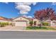 Charming single-story home with a well-manicured lawn, mature tree, and a two-car garage at 7860 Villa Del Fuego, Las Vegas, NV 89131