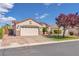 Paver driveway leads to the home's two-car garage, which is surrounded by landscaped curb appeal at 7860 Villa Del Fuego, Las Vegas, NV 89131