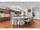 Bright kitchen with large island, breakfast bar, dark cabinets, stainless appliances, and open floor plan at 7860 Villa Del Fuego, Las Vegas, NV 89131