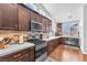Stylish kitchen with dark cabinets, stainless steel appliances, and a wine rack at 7860 Villa Del Fuego, Las Vegas, NV 89131
