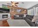 Comfortable living room with fireplace, mounted TV, and a dark leather couch at 7860 Villa Del Fuego, Las Vegas, NV 89131