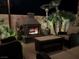 Cozy outdoor seating area with a stone fireplace, creating a warm and inviting ambiance for gatherings at 7860 Villa Del Fuego, Las Vegas, NV 89131