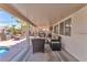 Spacious covered patio with comfortable seating, providing a relaxing outdoor living space and backyard views at 7860 Villa Del Fuego, Las Vegas, NV 89131