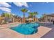 Sparkling backyard pool featuring mature palm trees, shade umbrella, patio furniture, and desert landscaping at 7860 Villa Del Fuego, Las Vegas, NV 89131