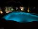 Inviting backyard pool with a unique water feature and lush landscaping, perfect for evening relaxation at 7860 Villa Del Fuego, Las Vegas, NV 89131