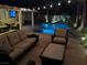Luxurious outdoor area with a sparkling pool, comfortable seating, and mature landscaping, perfect for entertaining at 7860 Villa Del Fuego, Las Vegas, NV 89131