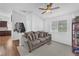 Cozy sitting room with couch and shelving, flowing into kitchen with wood flooring at 7860 Villa Del Fuego, Las Vegas, NV 89131