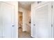 Bright hallway features neutral walls, carpet floors, and a glimpse into the adjacent bathroom at 7900 Pandora Sky St # 262, North Las Vegas, NV 89084
