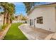 Tranquil backyard with artificial grass and mature palm trees, ideal for relaxation at 7968 Marbella Cir, Las Vegas, NV 89128