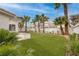 Beautiful backyard with artificial grass, palm trees, and a large patio area at 7968 Marbella Cir, Las Vegas, NV 89128