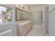 Bright bathroom featuring a vanity with drawers, a mirror, and a shower/tub combo at 7968 Marbella Cir, Las Vegas, NV 89128