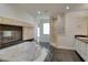 Bright bathroom with a fireplace, soaking tub, walk-in shower, and double vanity at 7968 Marbella Cir, Las Vegas, NV 89128