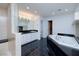 Elegant bathroom with a soaking tub, shower, vanity, and stylish black tile floor at 7968 Marbella Cir, Las Vegas, NV 89128