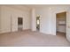 Spacious bedroom with multiple doors leading to closet and bathroom, plus neutral carpet at 7968 Marbella Cir, Las Vegas, NV 89128