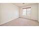 Bright bedroom with neutral carpet, a window, and ample space at 7968 Marbella Cir, Las Vegas, NV 89128