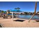 Inviting community lagoon area with sandy beach, lounge chairs, and clear, refreshing water at 7968 Marbella Cir, Las Vegas, NV 89128