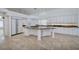 Open kitchen featuring white cabinets, granite countertops, stainless steel appliances, and a center island at 7968 Marbella Cir, Las Vegas, NV 89128