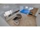 Overhead view of open kitchen layout with island, stone fireplace and adjacent living area at 7968 Marbella Cir, Las Vegas, NV 89128