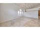 Bright living area with natural light, carpet, tile flooring, and modern chandelier at 7968 Marbella Cir, Las Vegas, NV 89128
