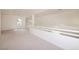 Upstairs loft area with carpeting, bright lighting, and railing overlooking the living room at 7968 Marbella Cir, Las Vegas, NV 89128