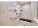 Luxurious walk-in shower with a bench, multiple shower heads, and elegant tile at 7968 Marbella Cir, Las Vegas, NV 89128
