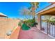 This backyard includes a turf area, desert landscaping, and a gated pool at 8348 Mountain Destiny Ave, Las Vegas, NV 89131