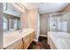 A spacious bathroom featuring an enclosed shower and tub accented with a single sink vanity at 8348 Mountain Destiny Ave, Las Vegas, NV 89131