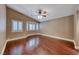 This bedroom is brightly lit with wood floors, ceiling fan, and shuttered windows at 8348 Mountain Destiny Ave, Las Vegas, NV 89131
