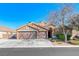 Charming single-story home with a three-car garage and well-maintained landscaping on a sunny day at 8348 Mountain Destiny Ave, Las Vegas, NV 89131