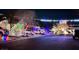 Festive neighborhood street view showcases holiday lights adorning houses and surrounding trees for a magical Christmas experience at 8348 Mountain Destiny Ave, Las Vegas, NV 89131