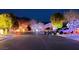 Festive neighborhood street view showcasing a wide variety of colorful lights and displays for a Christmas celebration at 8348 Mountain Destiny Ave, Las Vegas, NV 89131