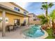 Backyard featuring a covered patio and lagoon-style pool with surrounding palm trees at 8407 Kettledrum St, Las Vegas, NV 89139